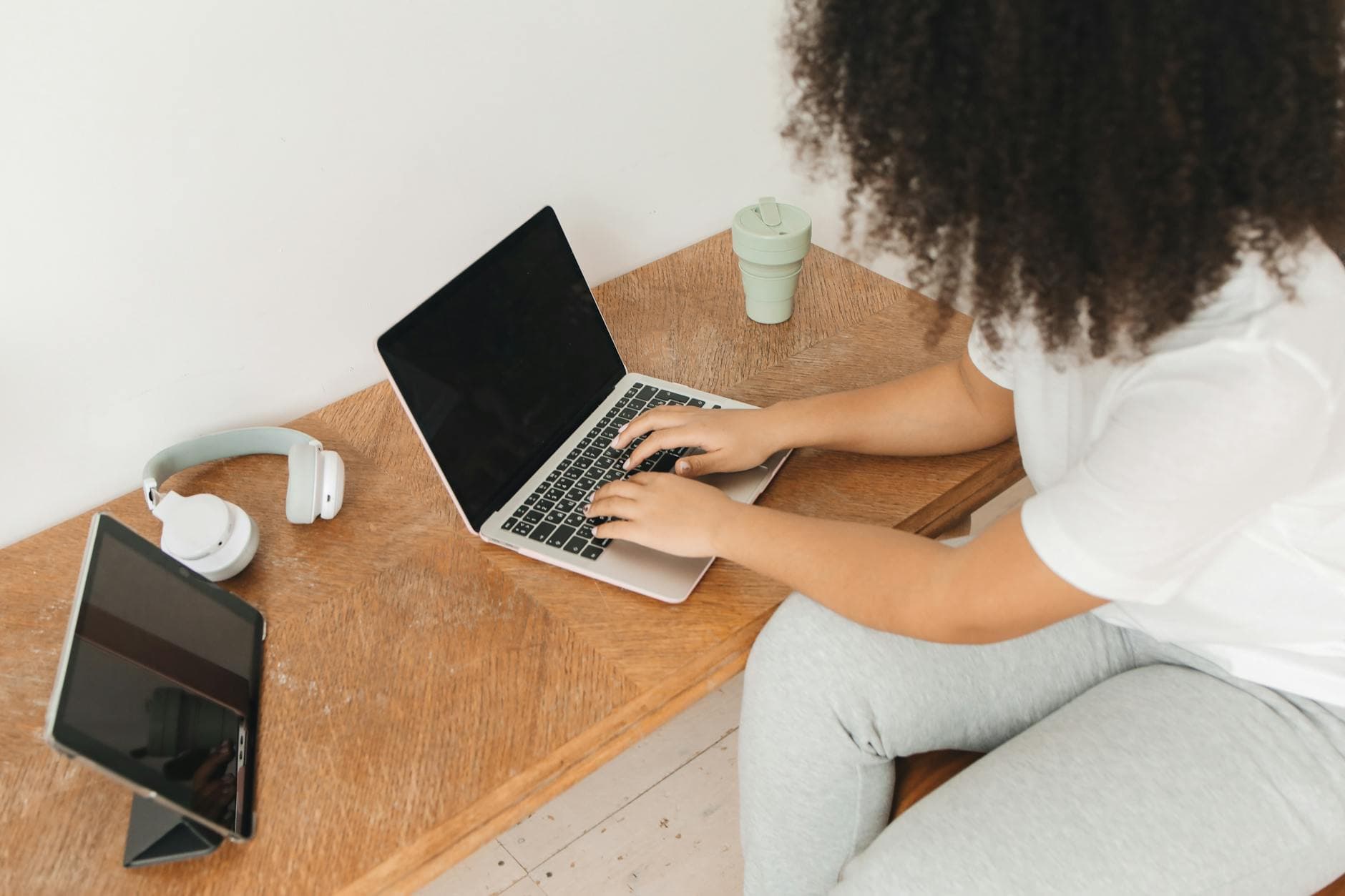 An introvert working peacefully at a desk with a laptop, soft natural light