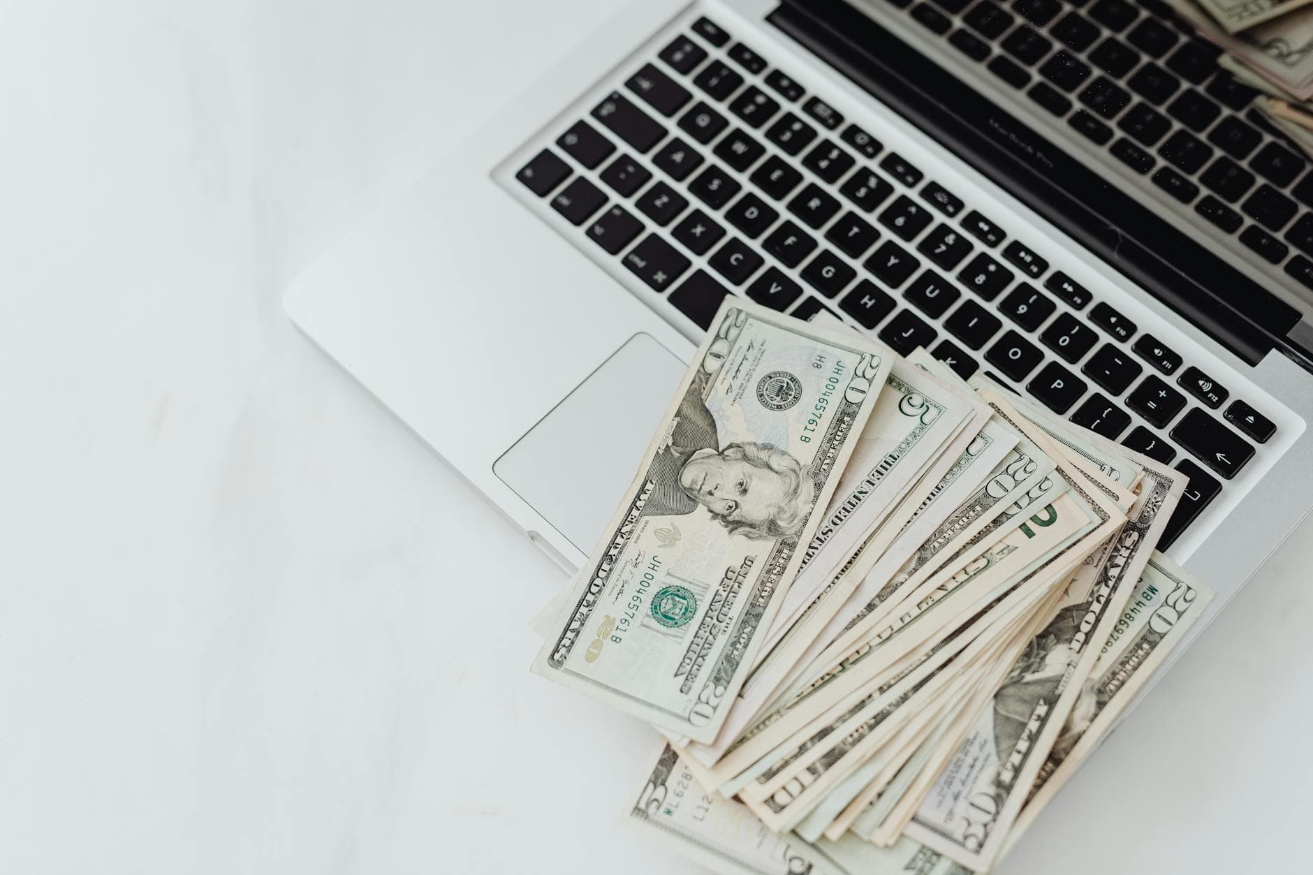 A person looking at a laptop screen with various icons representing different income streams, suggesting a diversified passive income portfolio.
