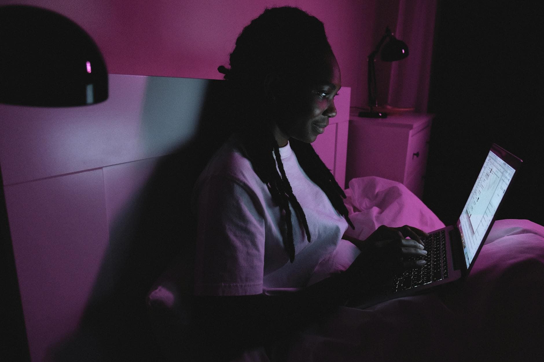 A person working on a laptop with AI-generated graphics appearing around them, symbolizing passive income.