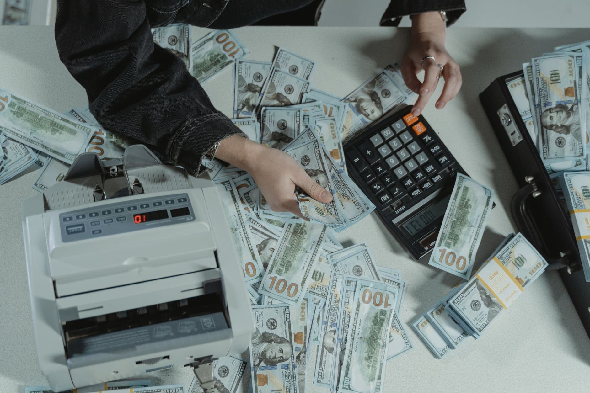 A freelancer's desk with a laptop displaying workflow automation software, gears turning in the background symbolizing passive income generation.